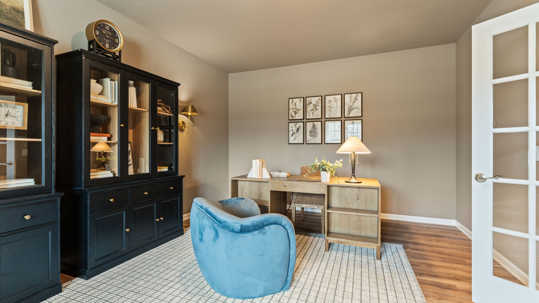 Office-space with wooden cabinets, desk, and sand colored wall