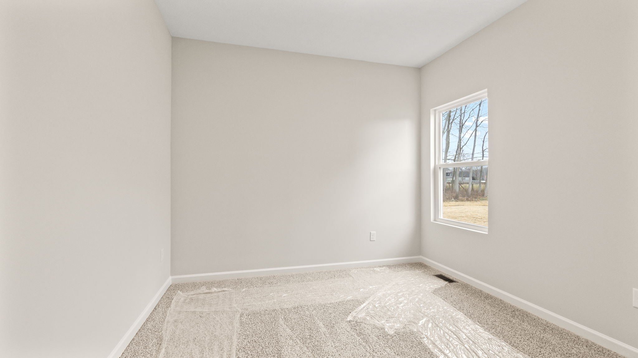 Carpeted bedroom with window