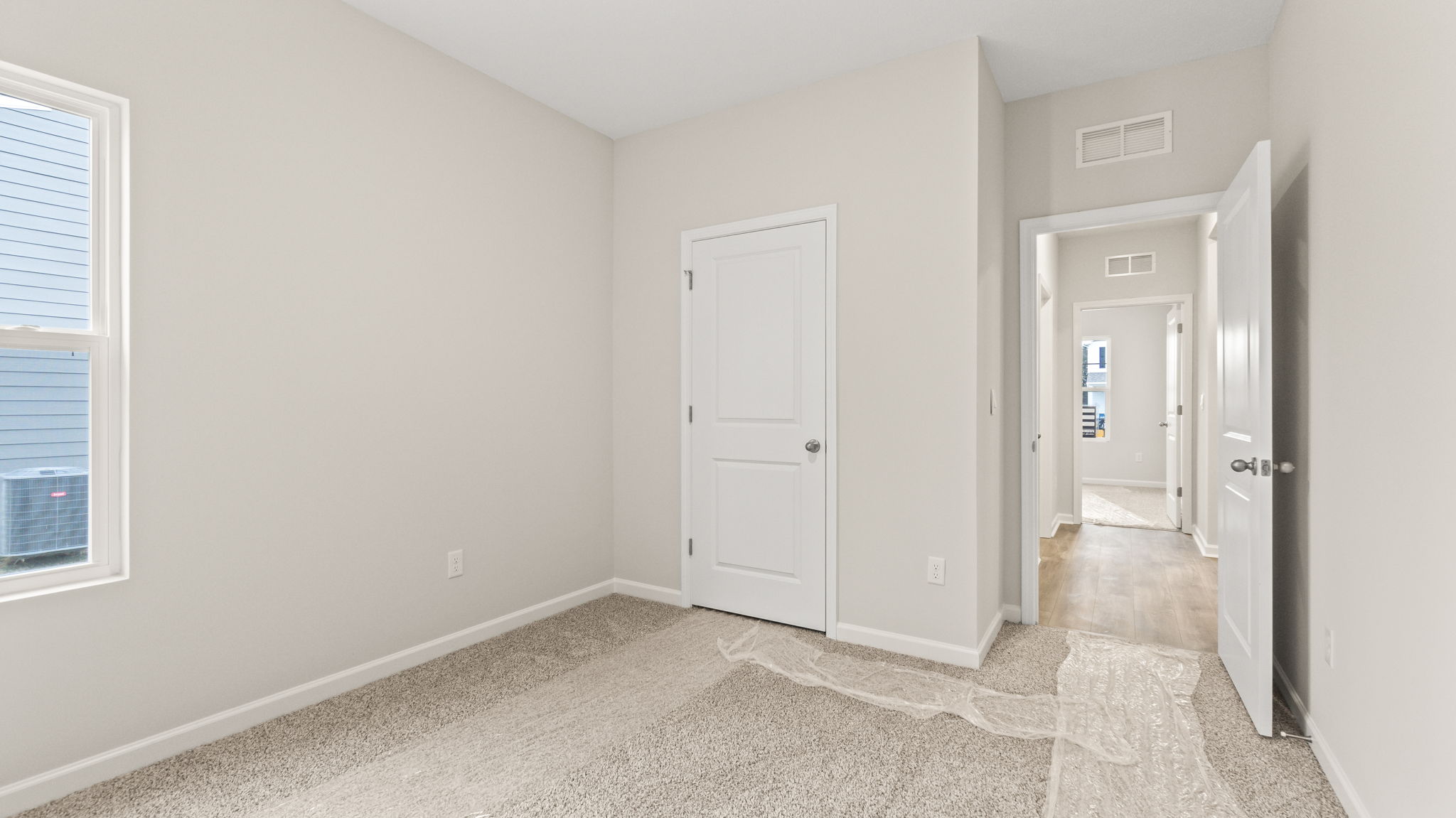 Carpeted bedroom with closet