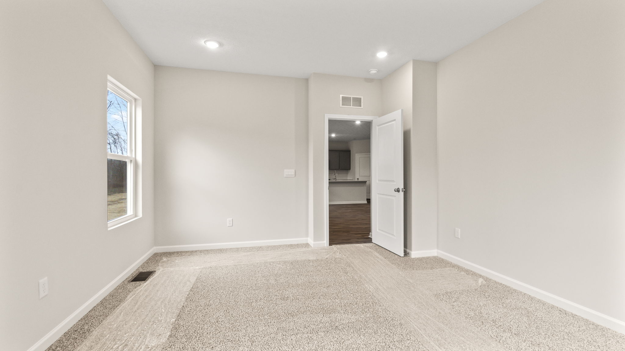 Primary bedroom with bathroom in view