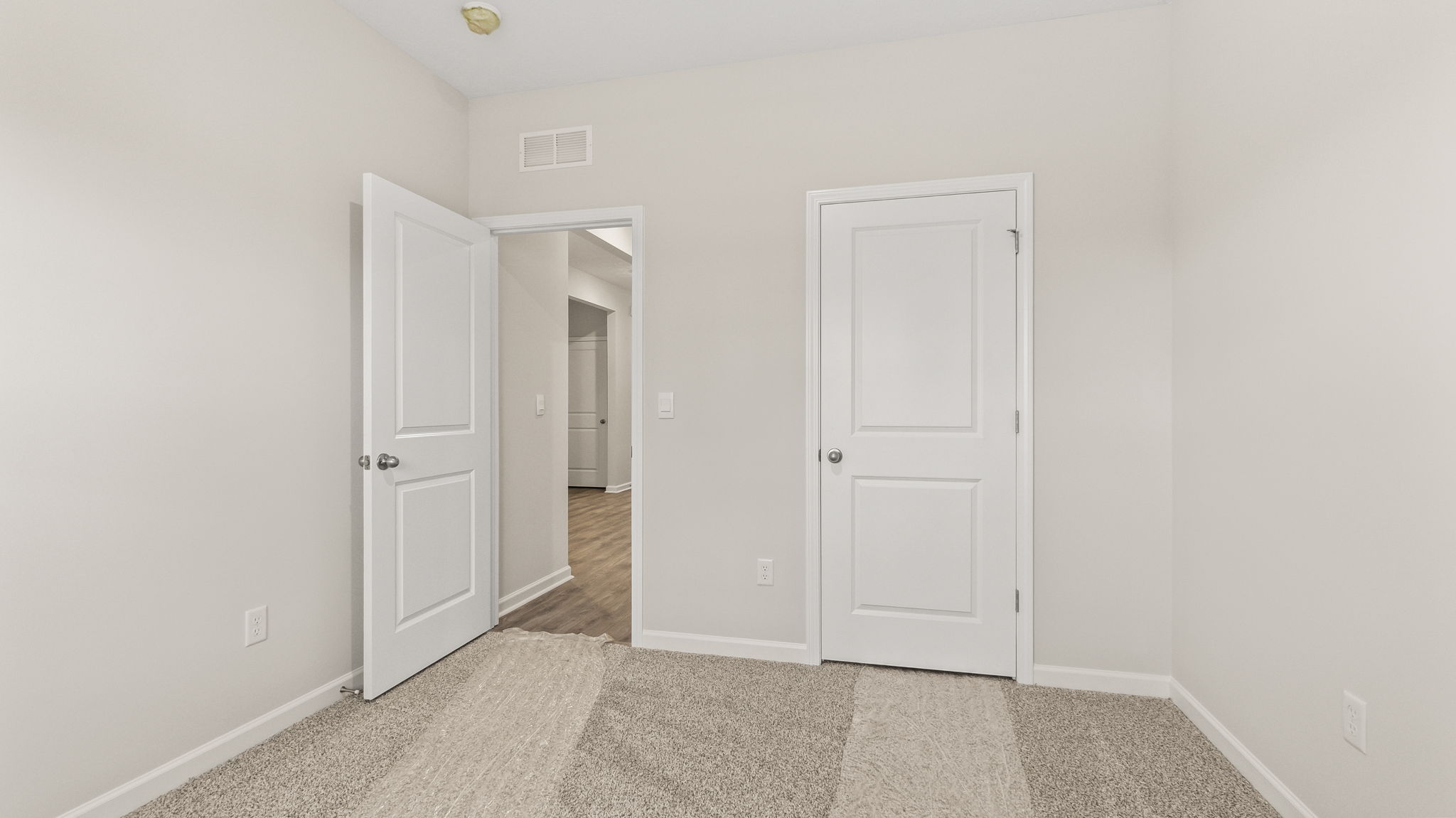 Carpeted bedroom with closet