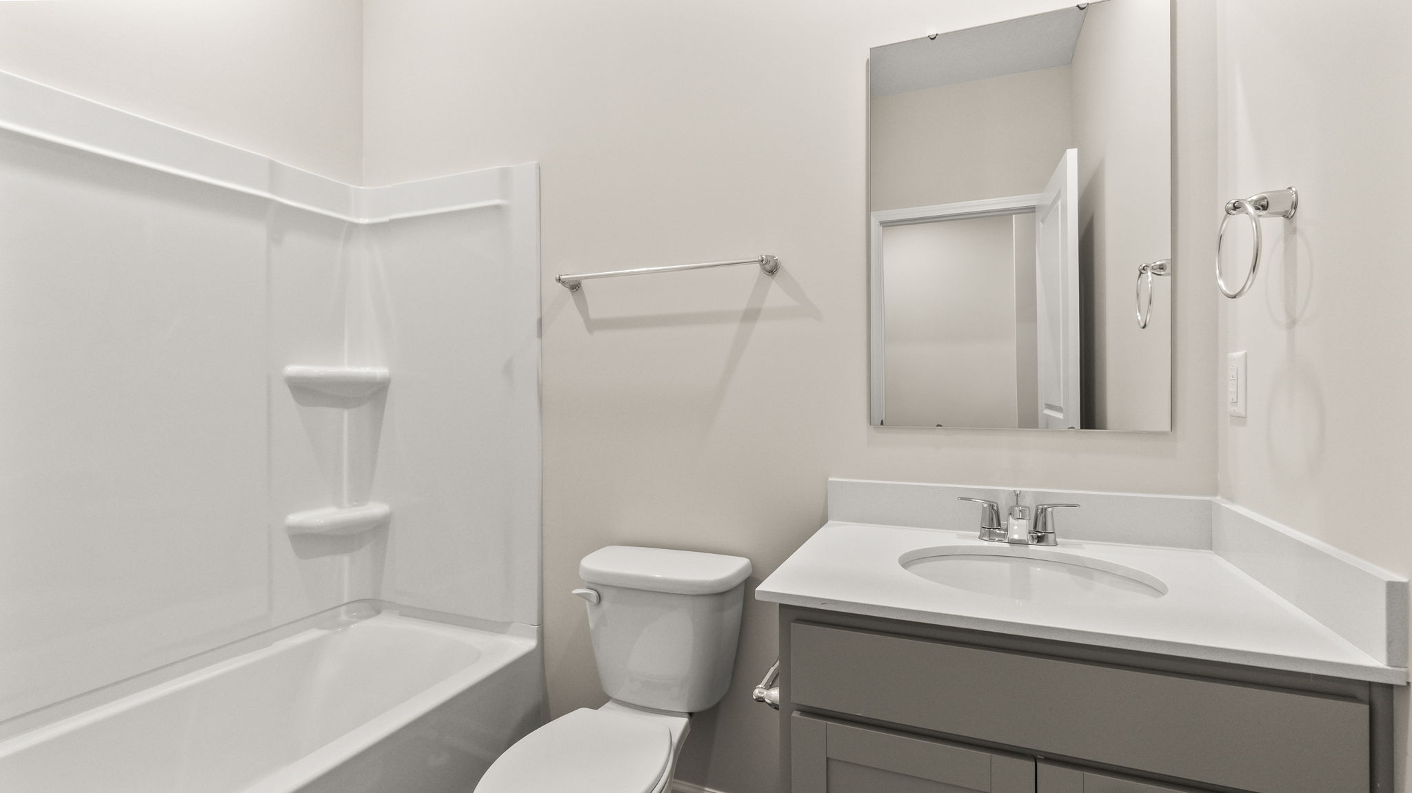 Bathroom with tub, toilet, and sink.