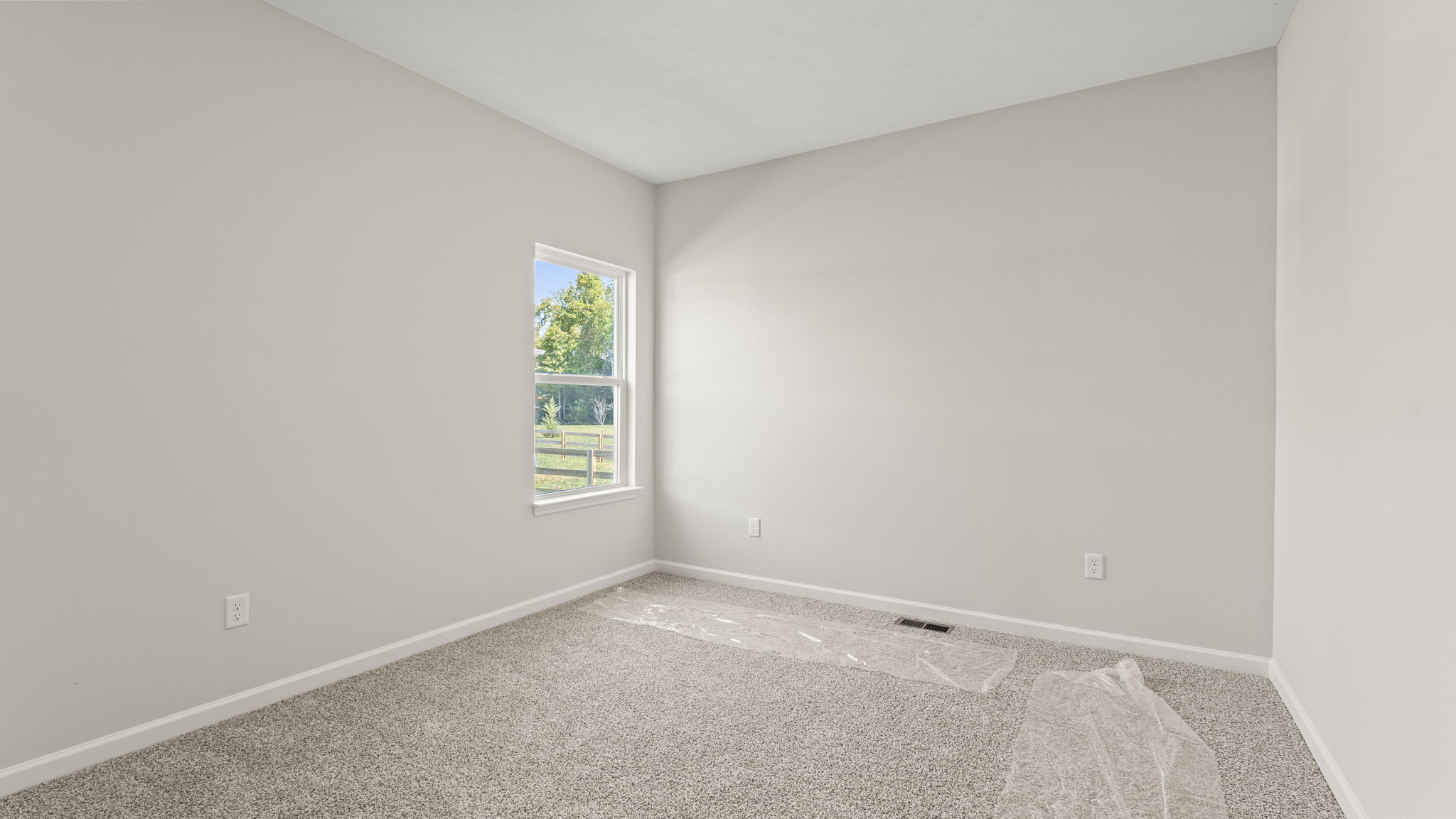 Carpeted bedroom with window