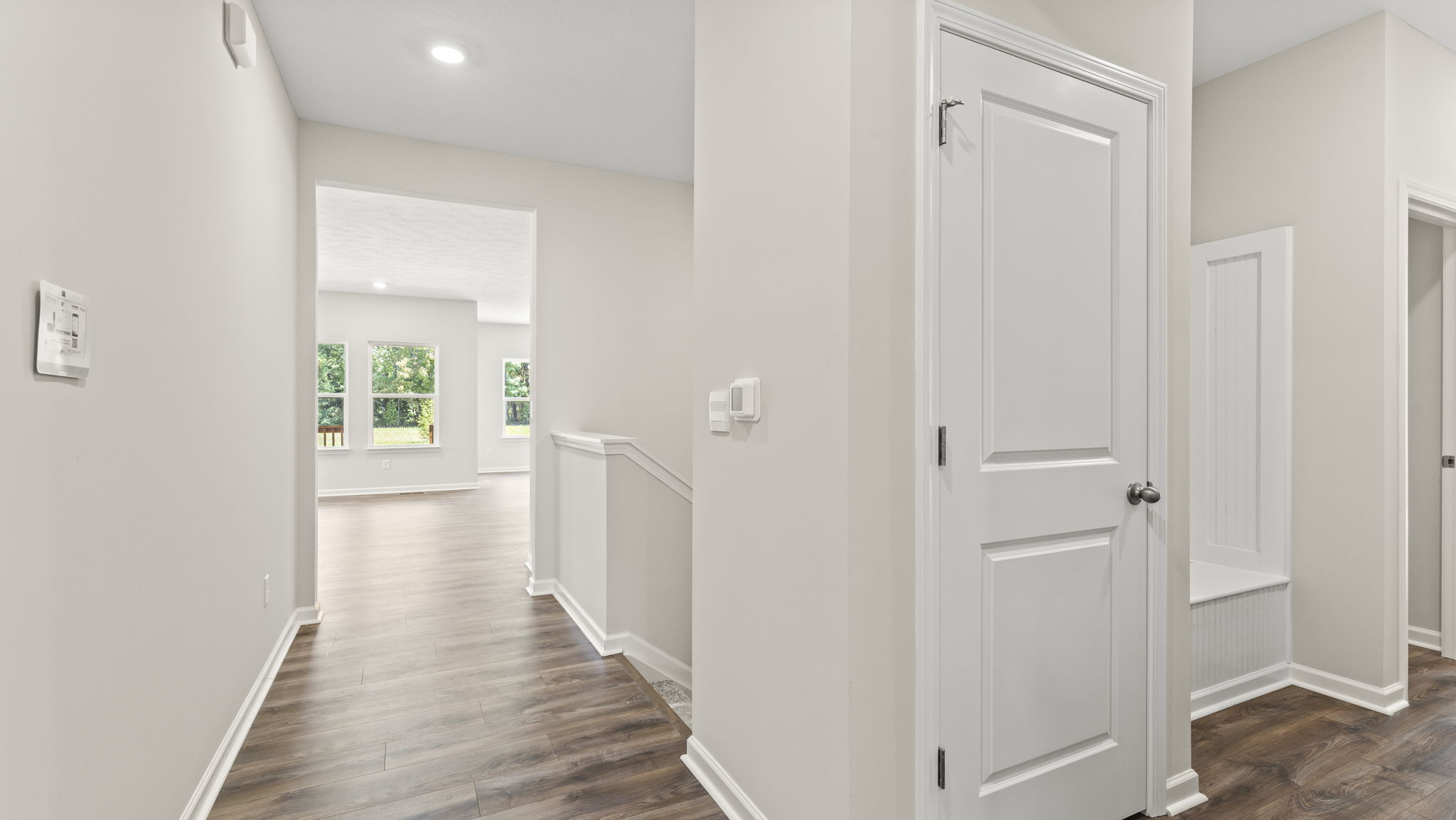 Front landing with mud room and closet on the right, kitchen and great room on the left.