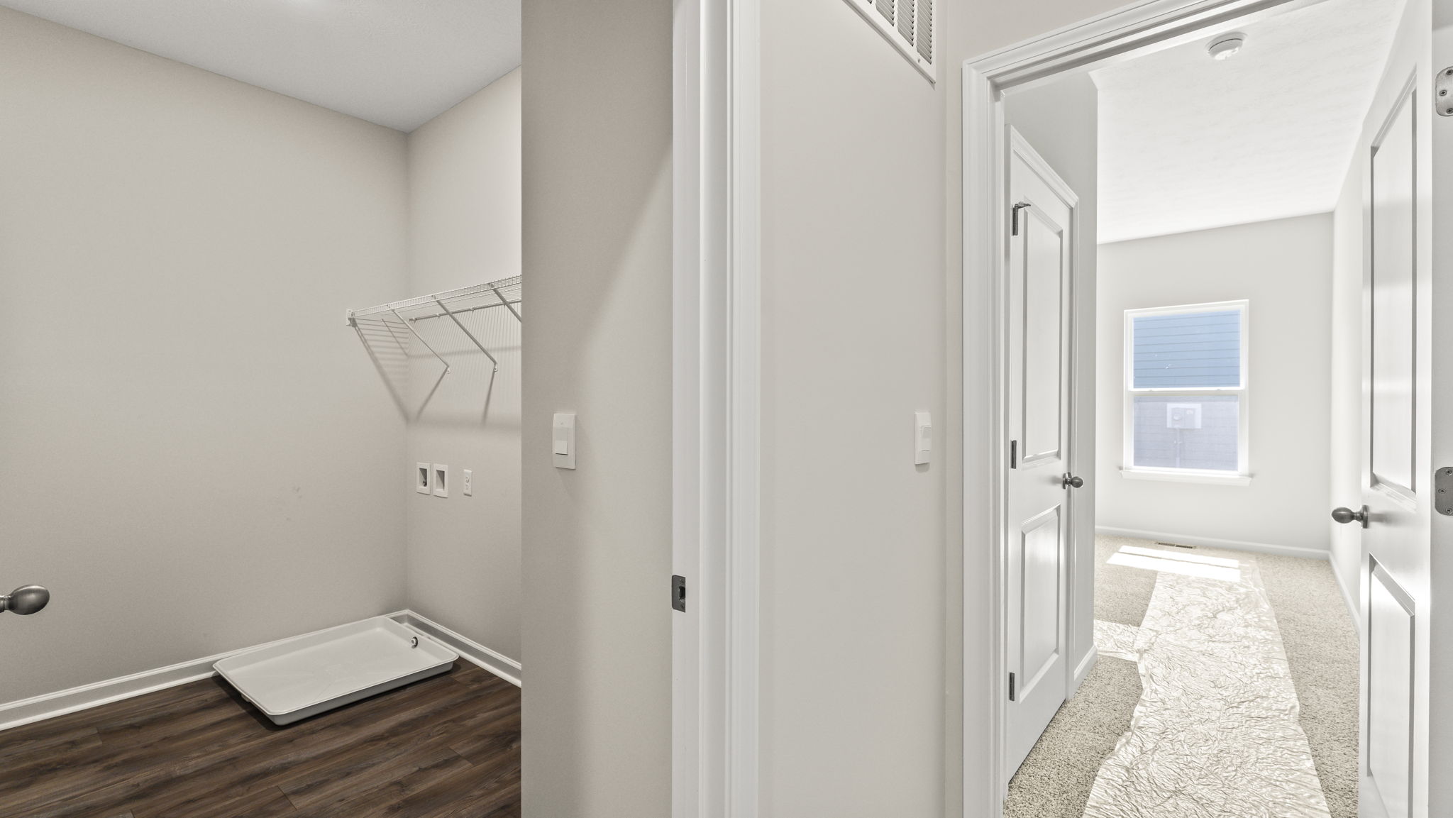 Door to laundry area on the left, bedroom on the right