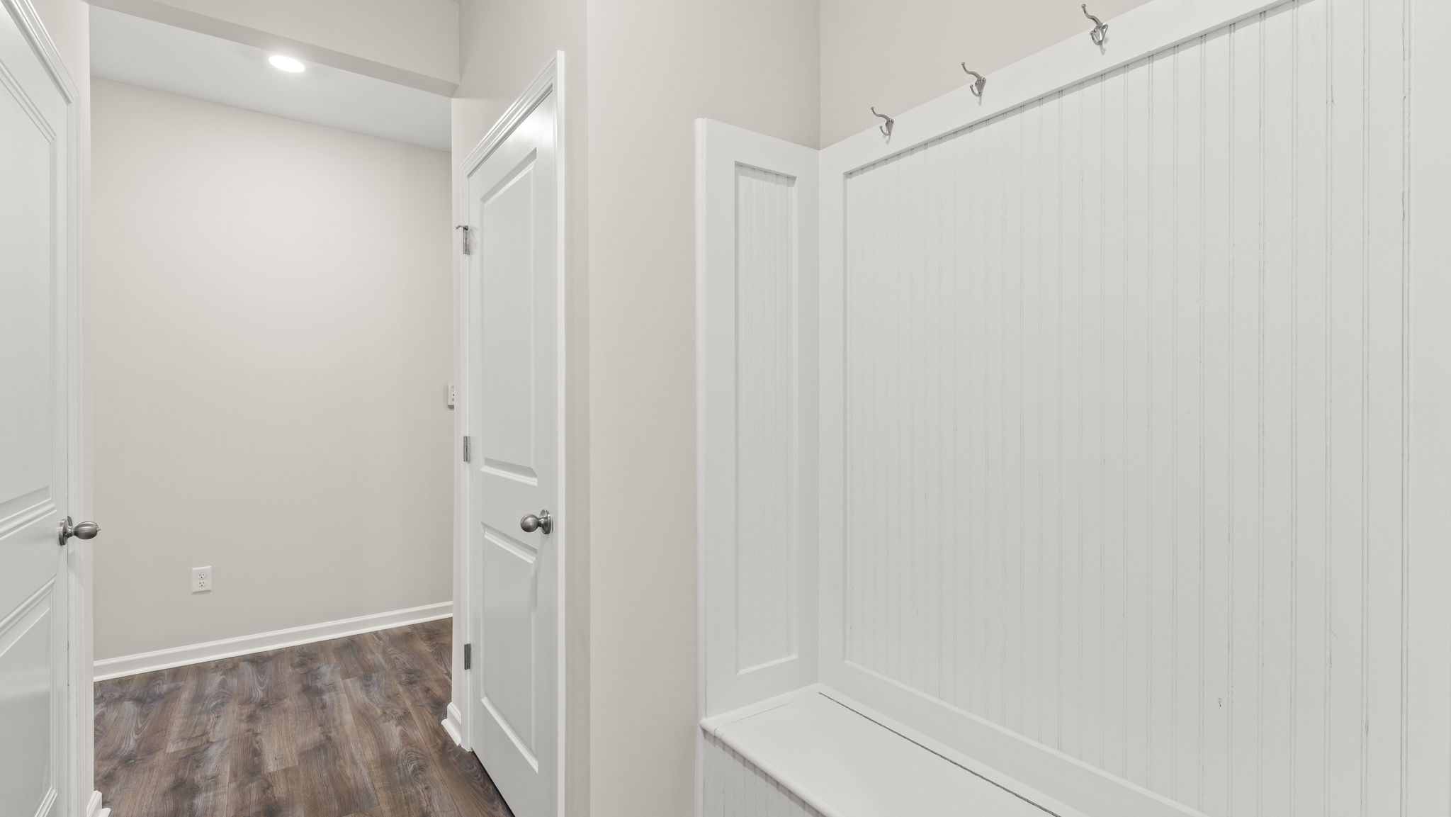 Closeup of mudroom storage area with hooks