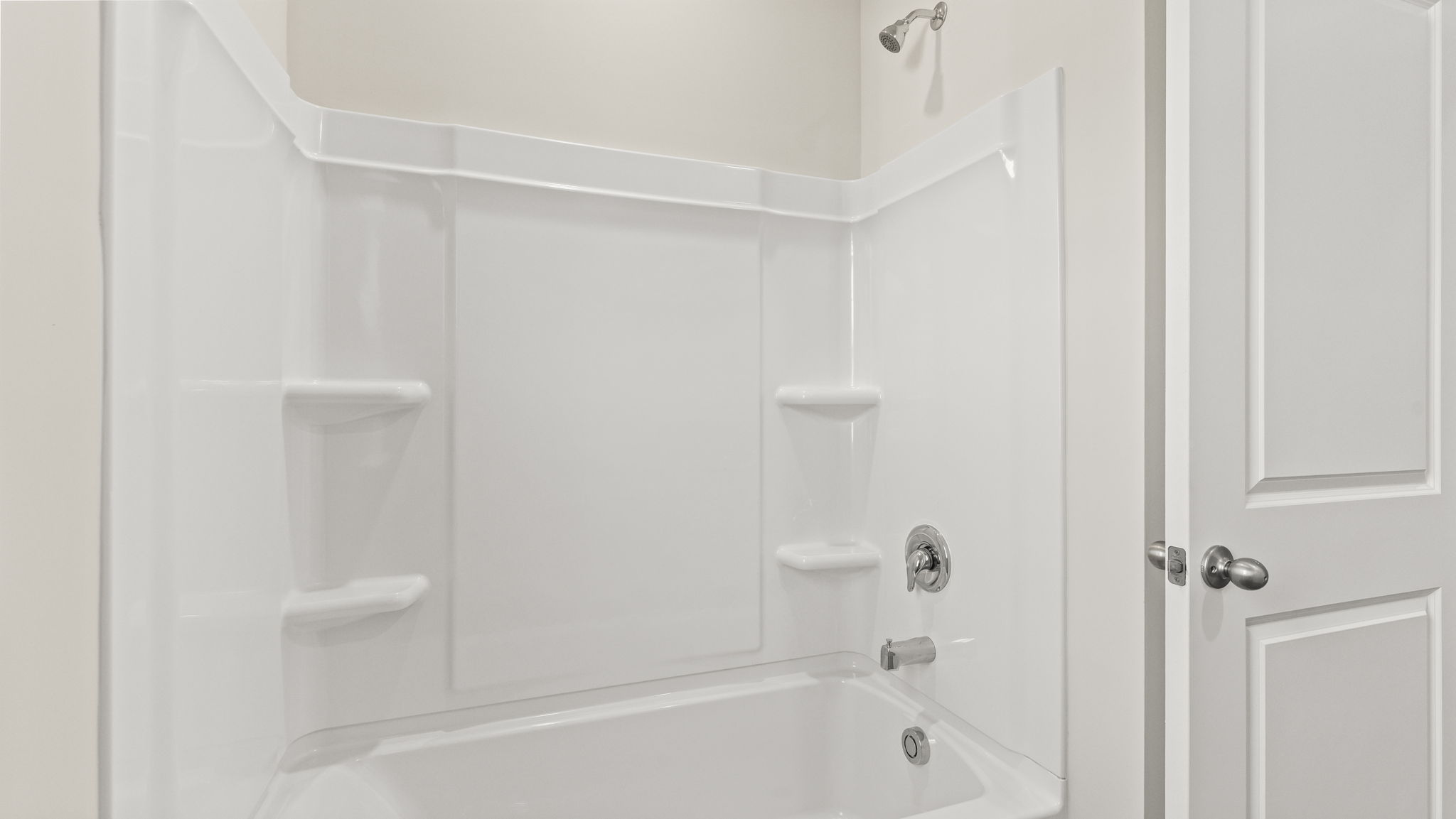 closeup of tub/shower with shelving.