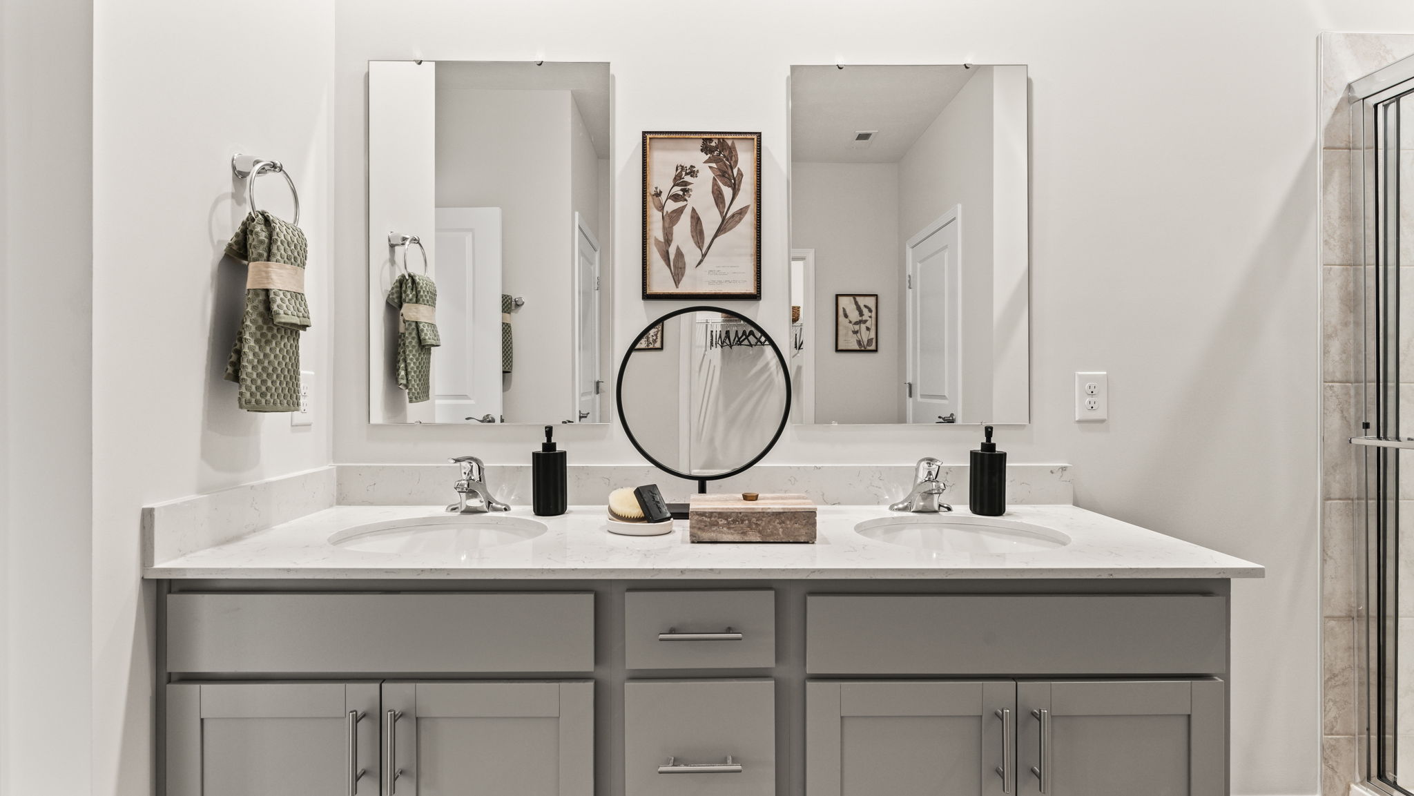 Wide image of spacious primary bathrom double bowl vanity with quartz countertop