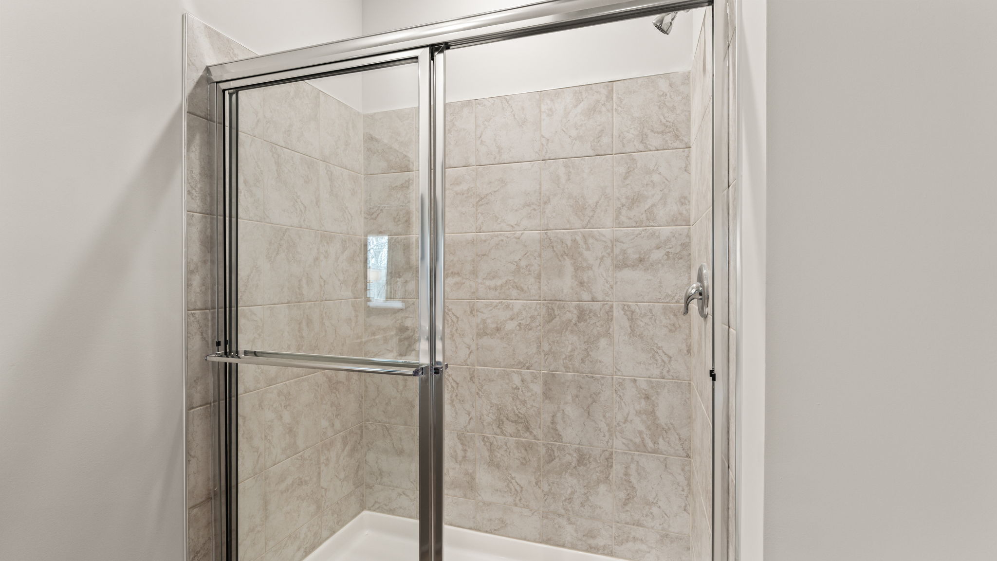 Closeup of walk-in shower with tile backing