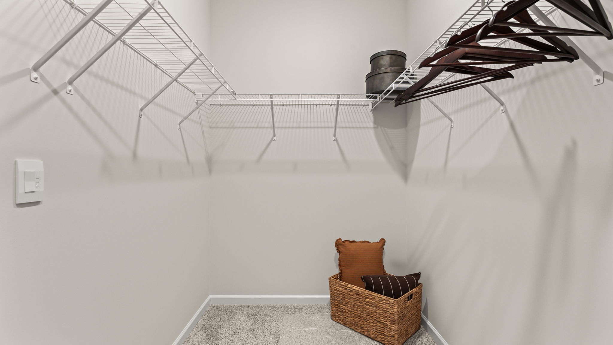 Walk-in closet with wire rack shelving,hangers, and basket