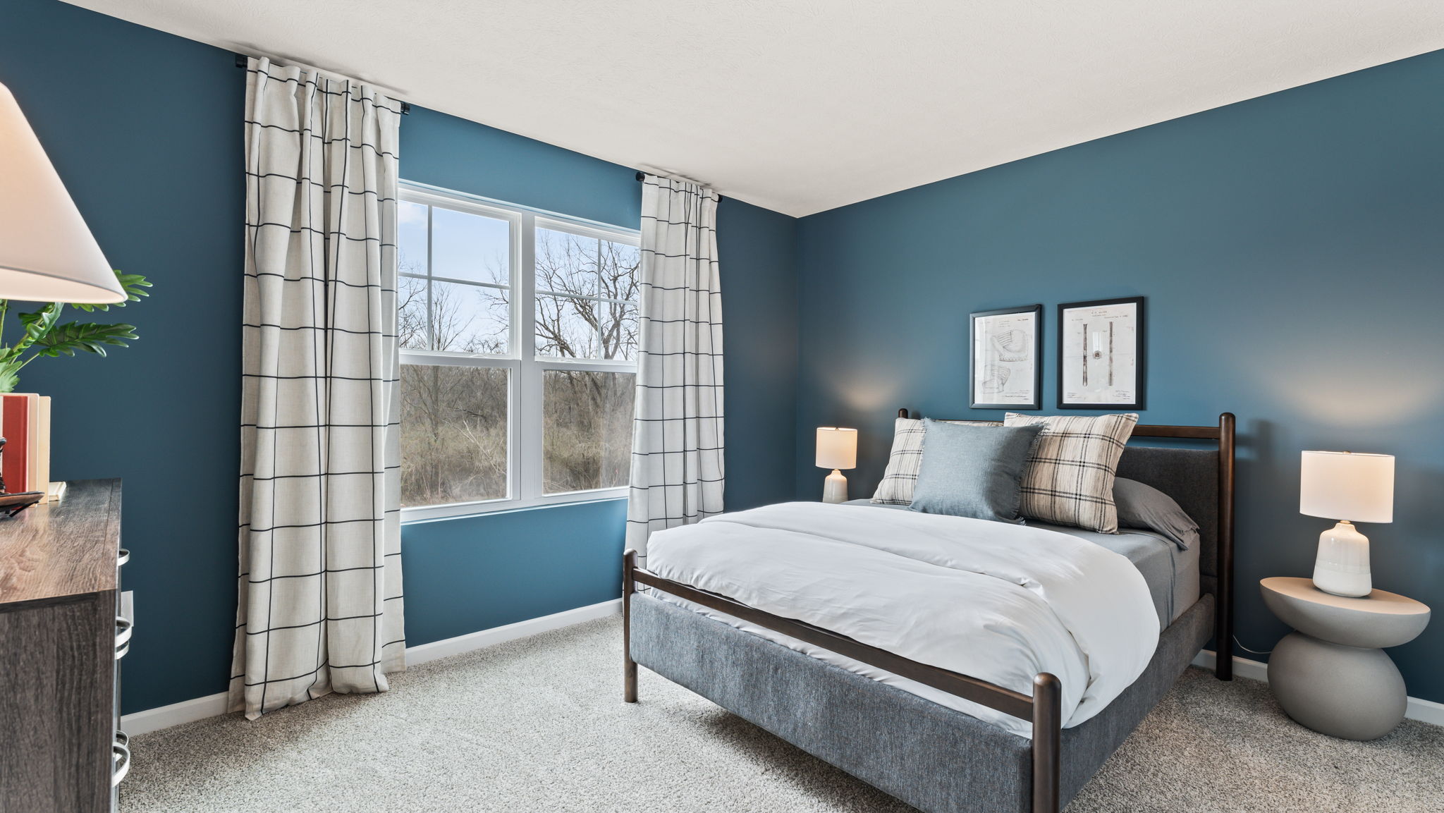 Bedroom 2 with deep blue wall paint and coastal blue queen bed frame