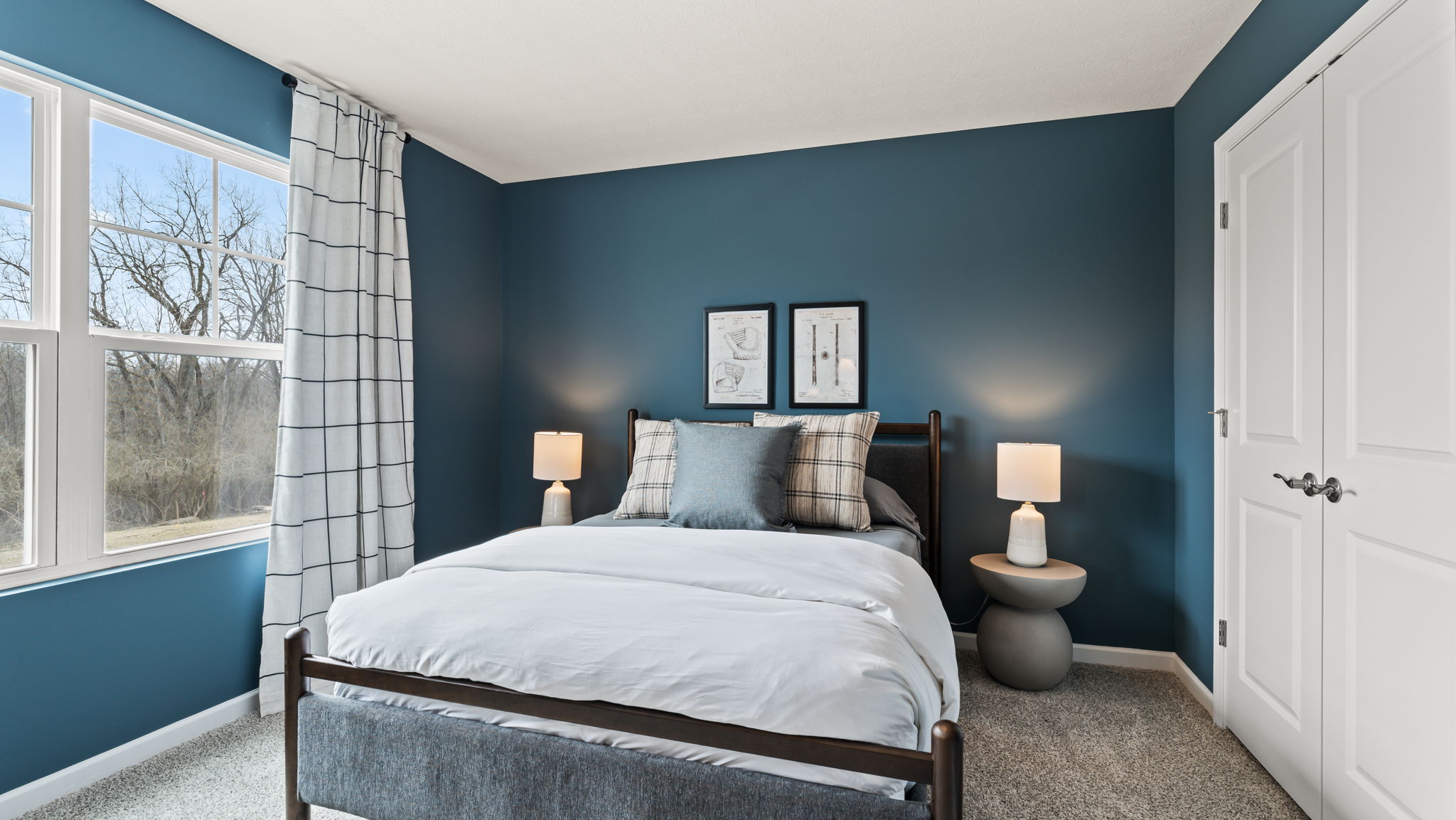 Bedroom 2 with deep blue wall paint and coastal blue queen bed frame