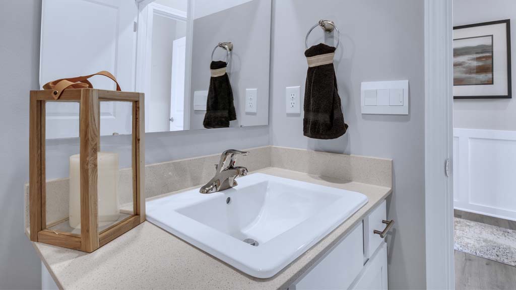 close up on white sink in shared bathroom.
