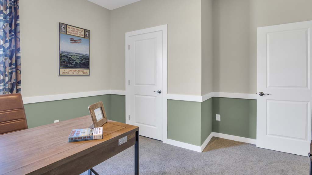 side view of desk with door to closet showing.