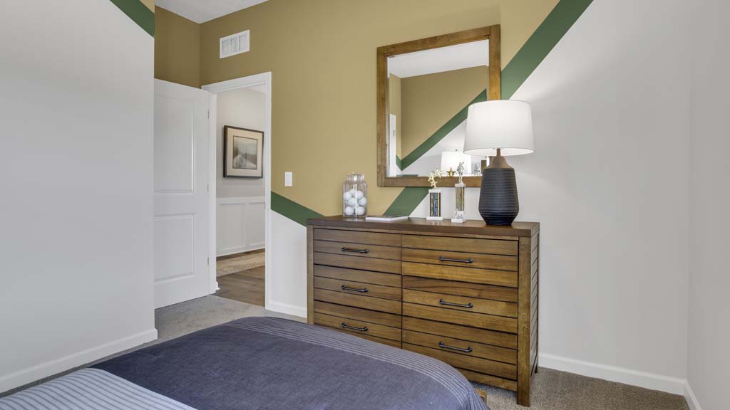 close up of dresser in lacrosse room on left side of bed.