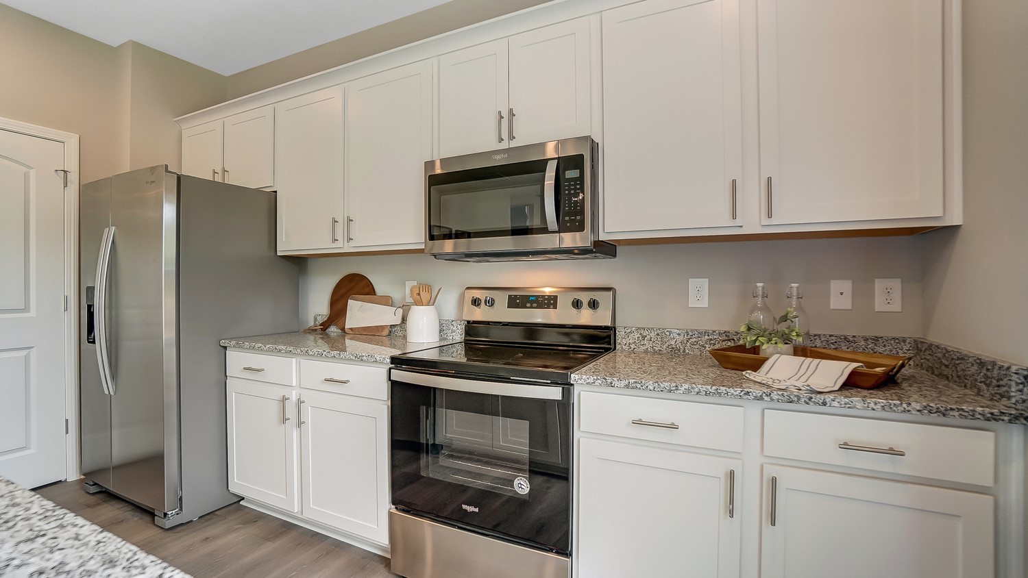 close up of kitchen cabinets and stainless steel appliances and granite countertops.
