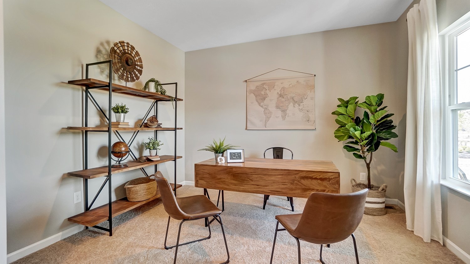 Office view with wooden desk and shelving with great natural light.