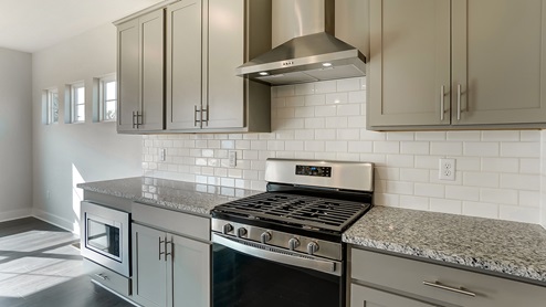 kitchen counters with gas range and exhaust