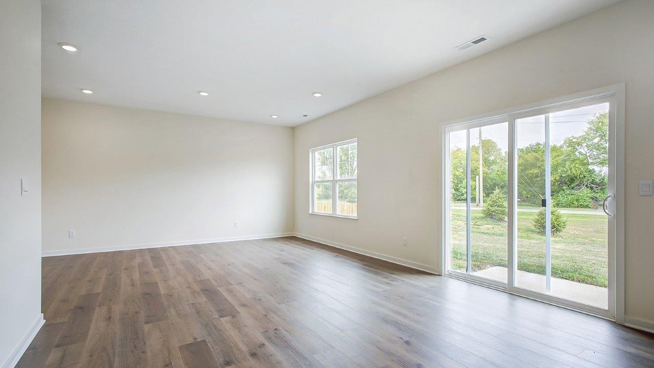 great room with double window and rear sliding door