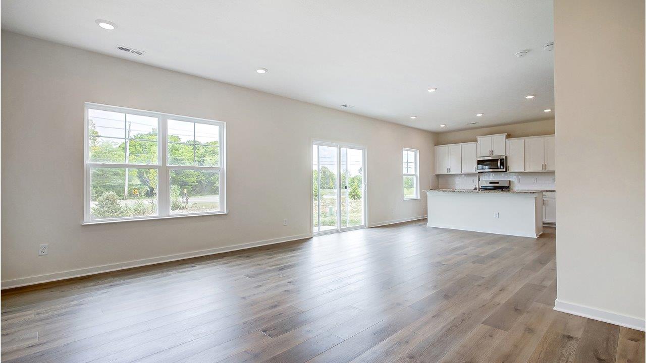 great room with single window, rear sliding door and kitchen