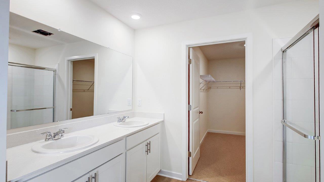 ensuite bath with double vanity and walk in closet