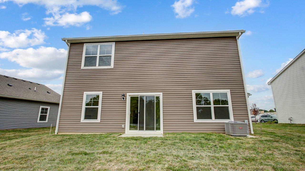 two story home with brown siding rear exterior