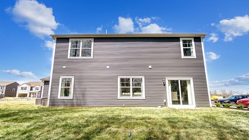 2 story home with grey siding rear exterior