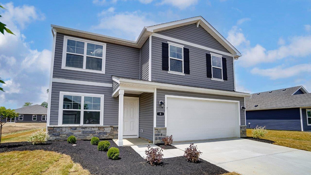 two story home with grey siding, covered entry and two car garage