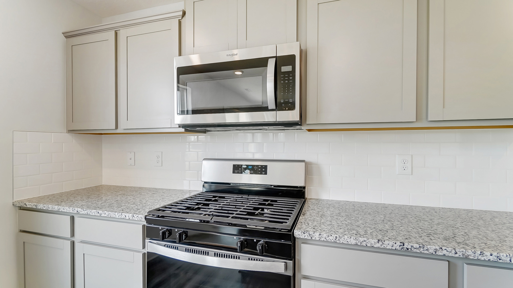 grey cabinets, stainless steel microwave and range