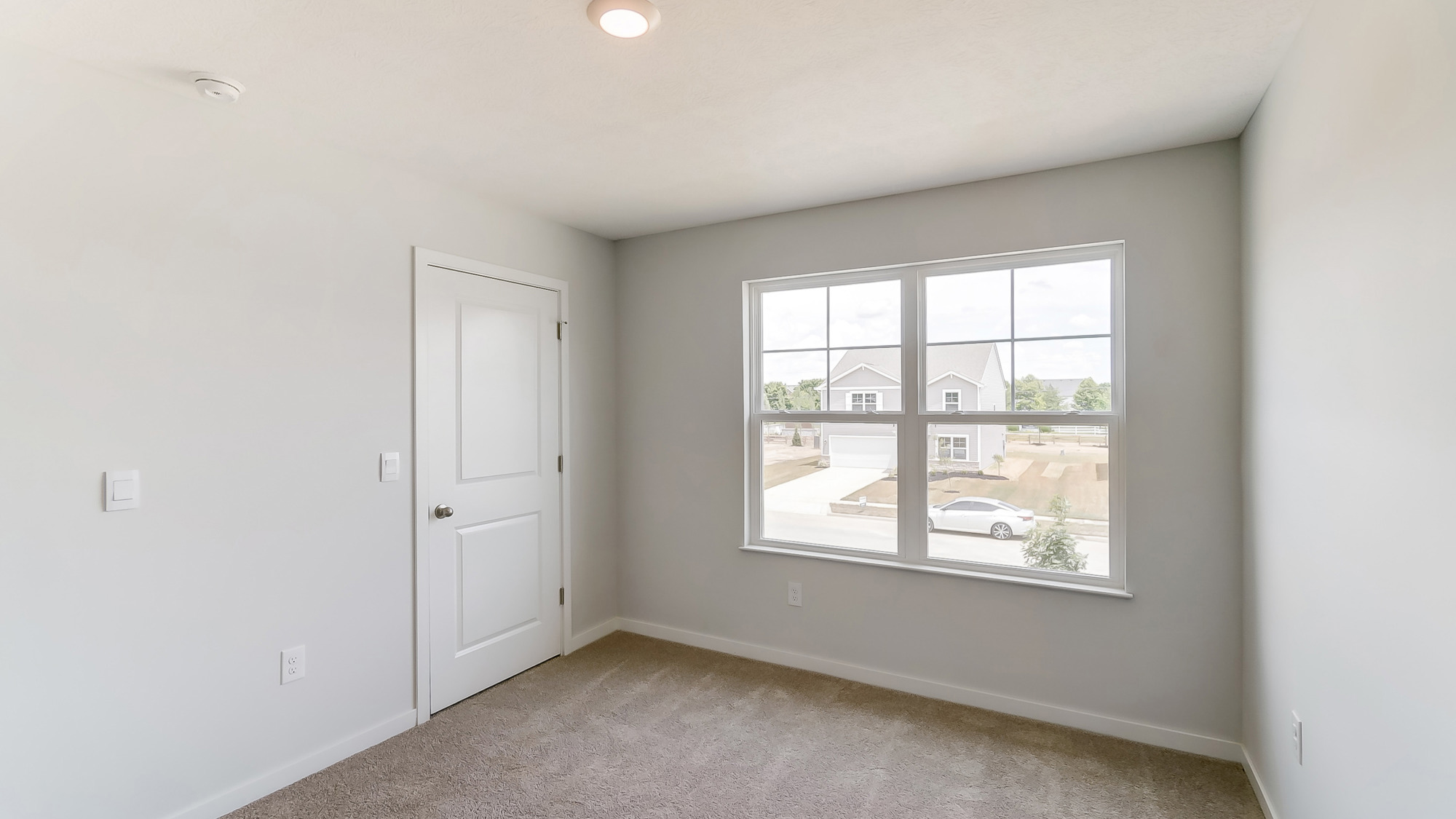 second bedroom with double window and closet