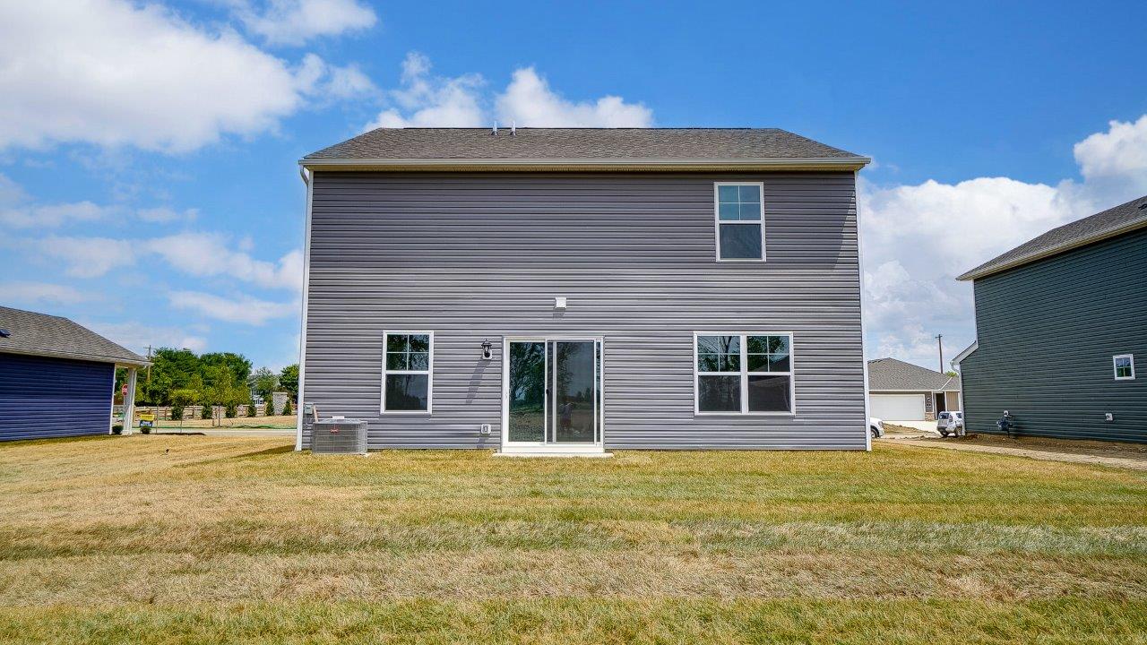 two story home with grey siding rear exterior