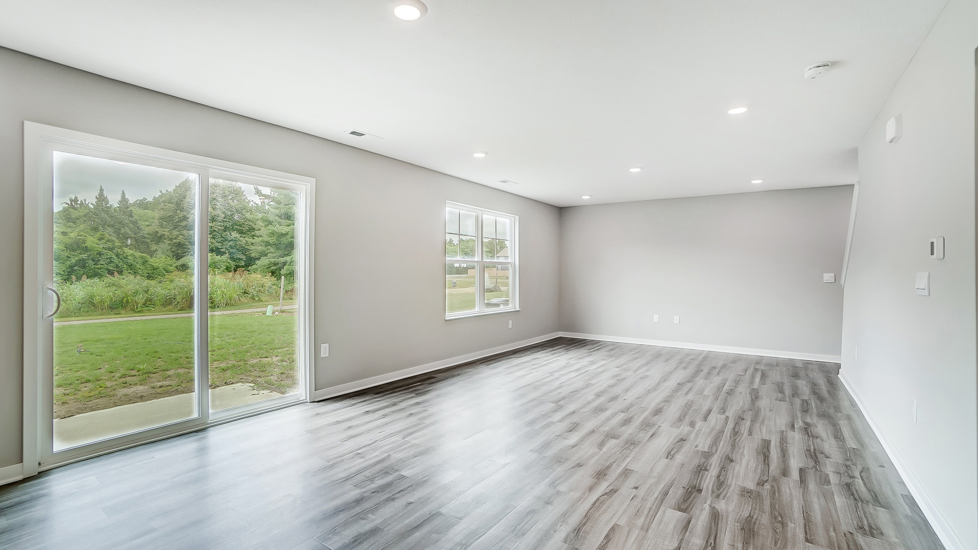 great room with rear sliding door and double window