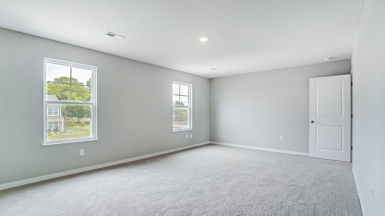 primary bedroom with single windows and entry