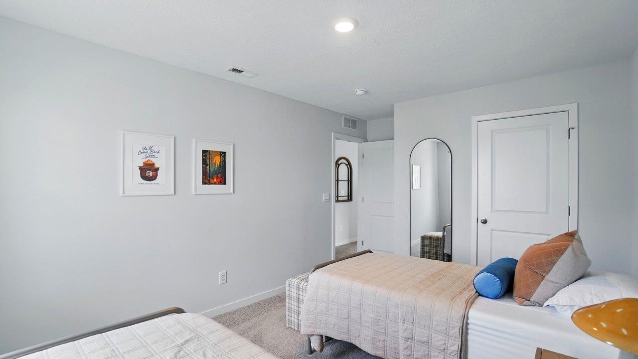 bedroom featuring 2 twin beds with orange bedding and a window