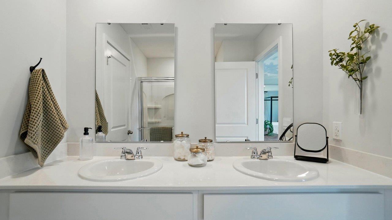 bathroom featuring dual vanity sinks with mirrors above