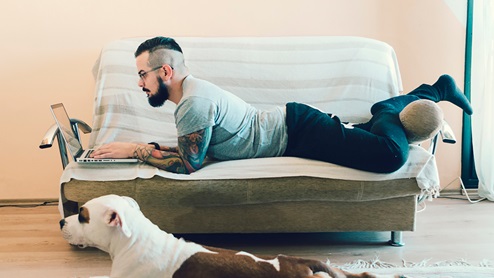 man and dog on couch lifestyle photo