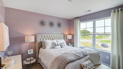 fourth bedroom with queen bed, side tables and double window