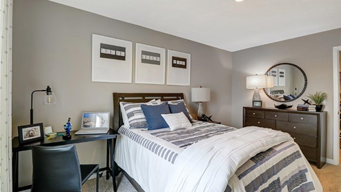 third bedroom with queen bed, desk and dresser