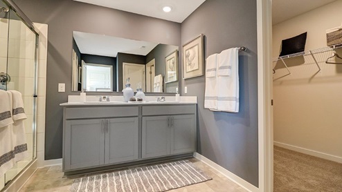 ensuite bath with double vanity and walk in closet