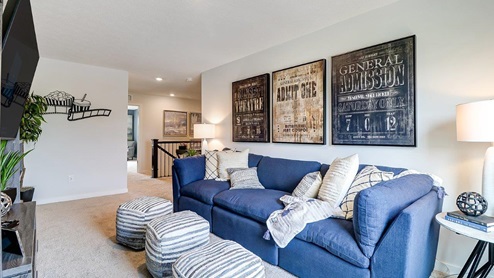furnished flex loft space with couch and ottomans