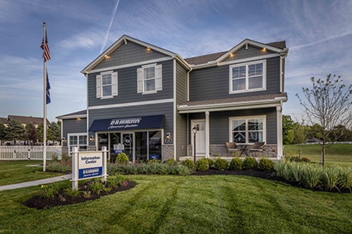 two story model home with blue siding, covered front porch, three car garage storefront