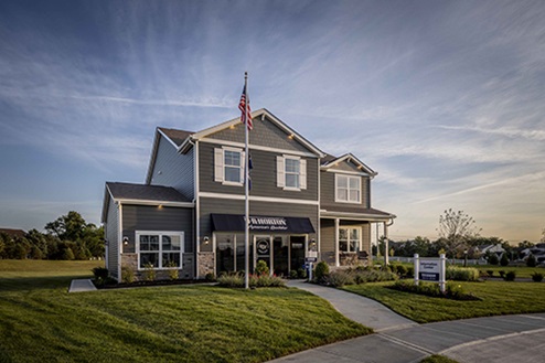two story model home with blue siding, covered front porch, three car garage storefront