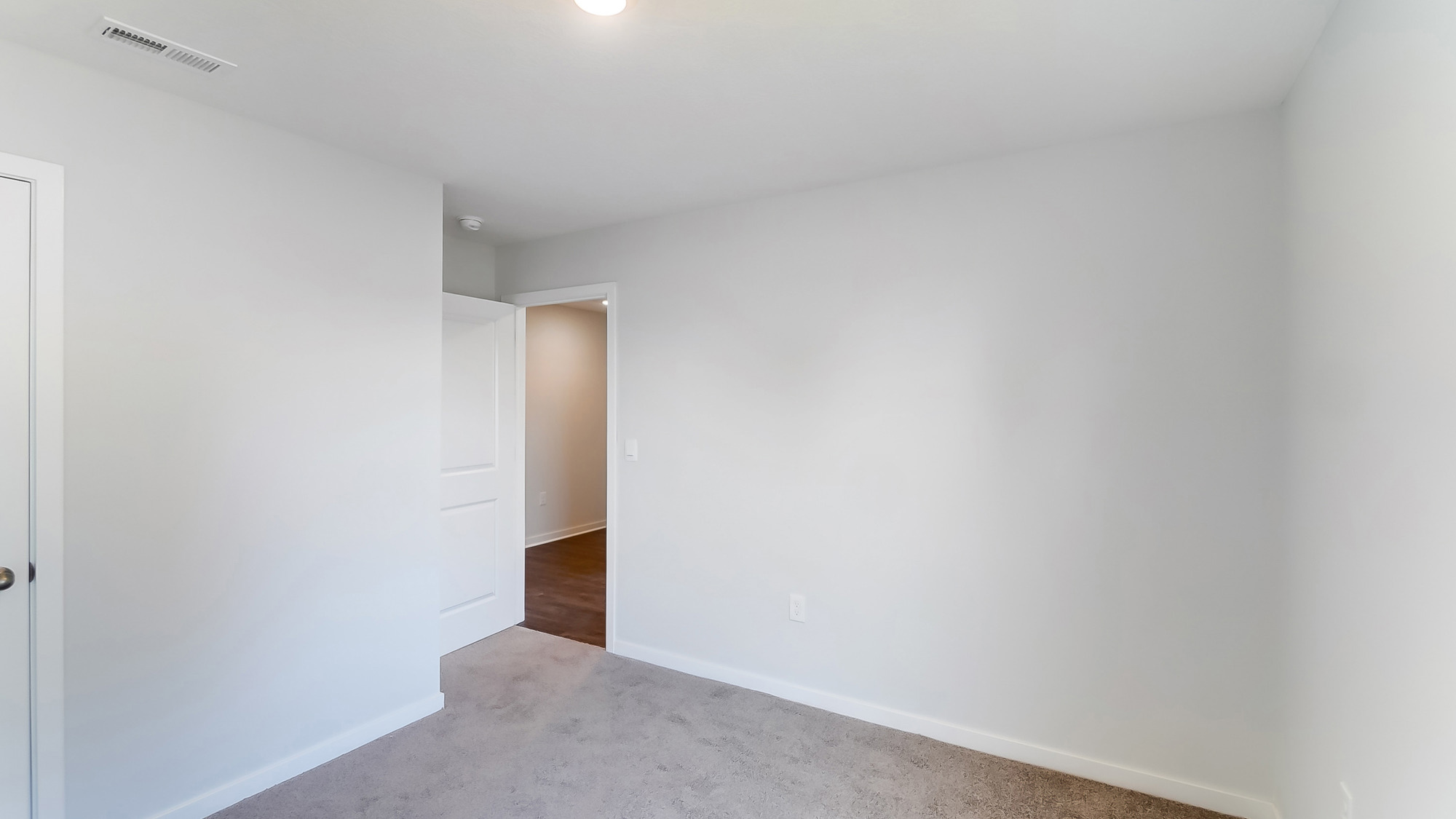 View of bedroom overlooking the closet and hallway doors