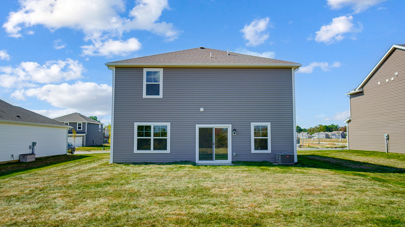 Spacious backyard with a manicured lawn.