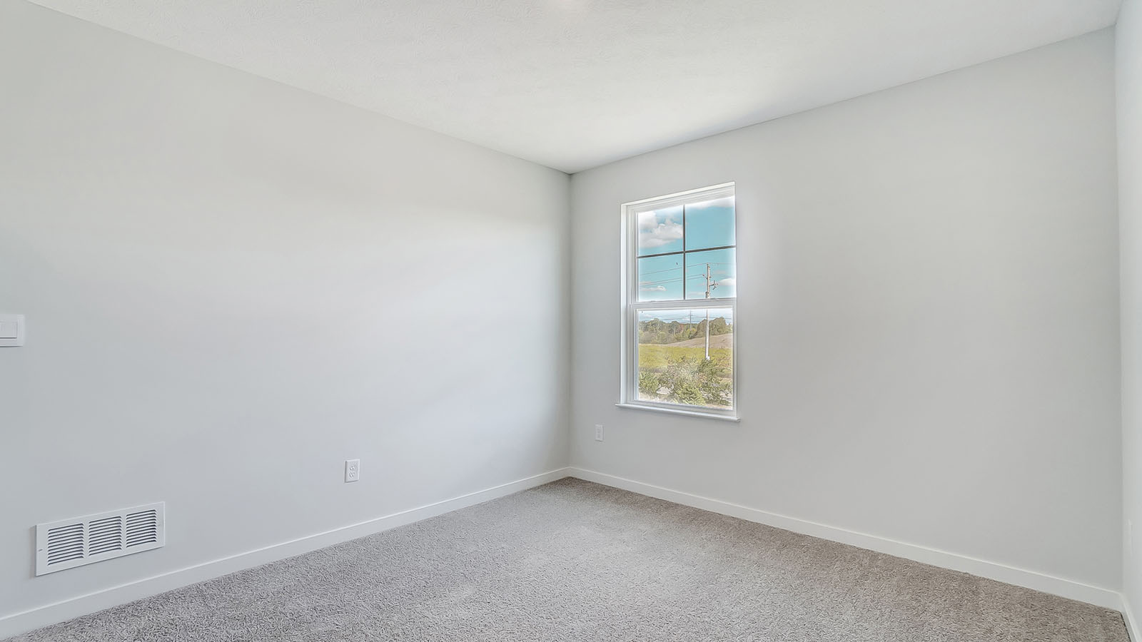 Bedroom with neutral walls, closet space, and natural lighting.