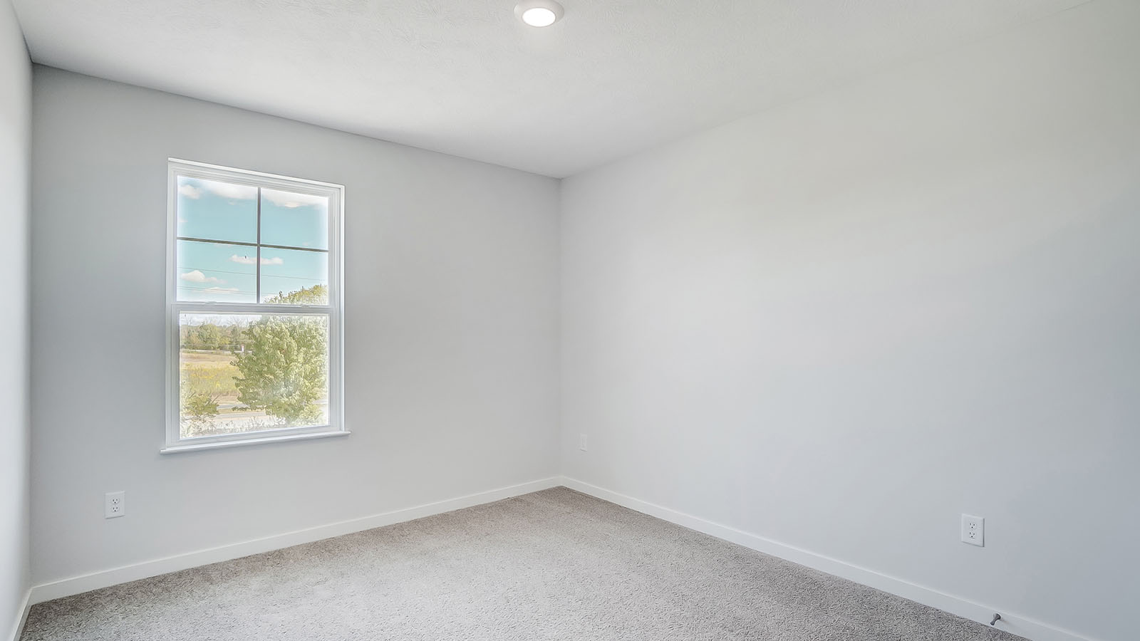 Bedroom with neutral walls, closet space, and natural lighting.