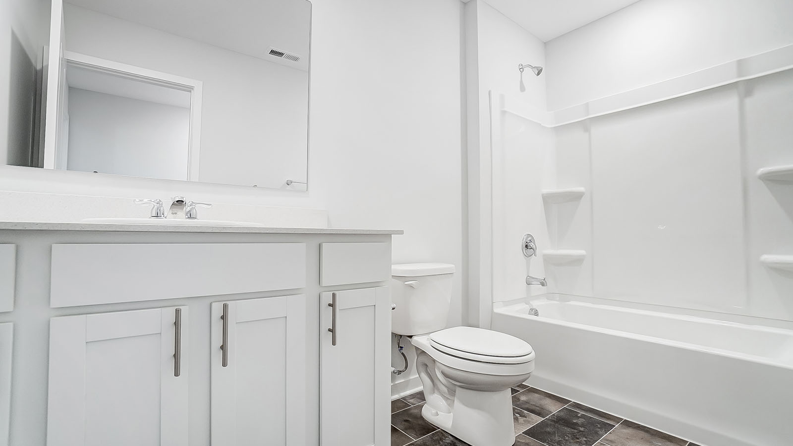 Bathroom featuring a sink, toilet, and shower tub.