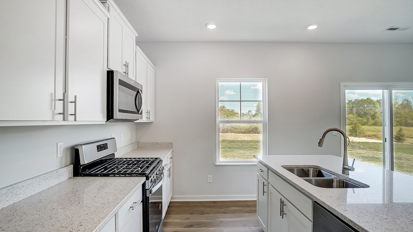 Kitchen featuring cabinets, new stainless steel appliances, and a large standing island.