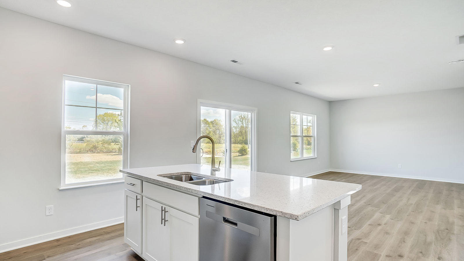 kitchen with white cabinetry, large island, and stainless steel appliances
