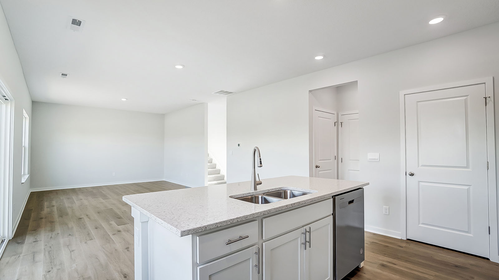 Kitchen featuring cabinets, new stainless steel appliances, and a large standing island.